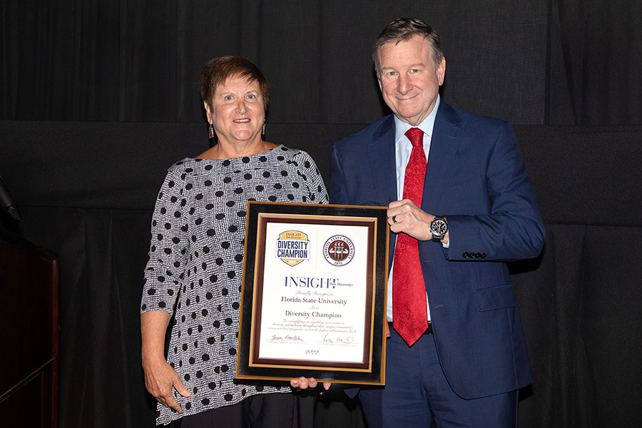 FSU President Richard McCullough accepts INSIGHT Into Diversity's Diversity Champion Award from publisher Lenore Pearlstein on during a ceremony Oct. 11, 2022, at the Askew Student Life Center. (FSU Photography Services)