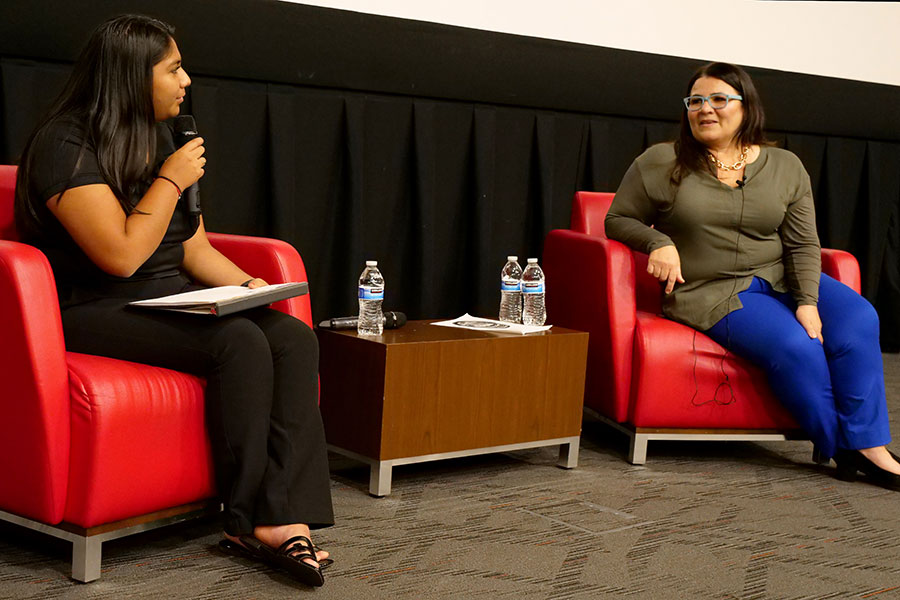 Yesenia Yataco, a board member of the Hispanic/Latinx Student Union, interviews Denise Soler Cox following her keynote at the Hispanic/Latinx Cultural Celebration.