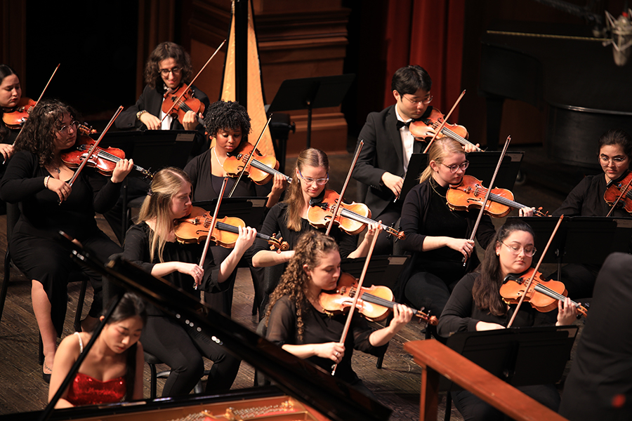 Violin section accompanies piano soloist, Xu Han. (Jenna Montes)