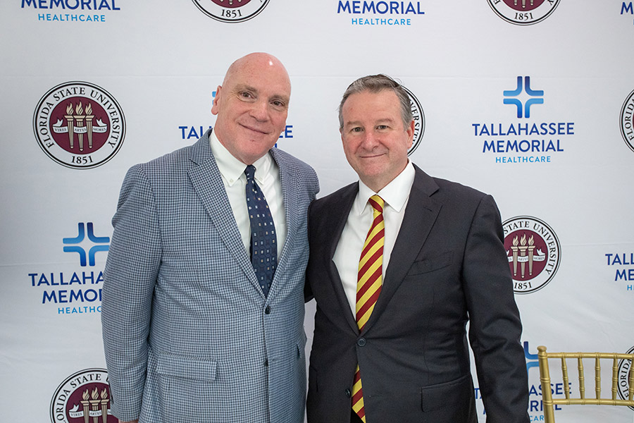 TMH President and CEO Mark O’Bryant and FSU President Richard McCullough pose together after an announcement of designation of land on which the university will build an academic health center held Wednesday, March 8, 2023, in the Dozier Atrium at TMH. (FSU Photography Services)