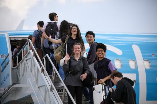 USO Musicians Rebeca Masalles, Masayoshi Arakawa, Tyler Tran, and Angela King happily wave goodbye as they board the orchestra's chartered flight to the Dominican Republic.