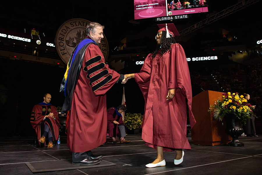 Florida State University's President Richard McCullough and a graduate shake hands during spring commencement Friday, May 5, 2023, at the Donald L. Tucker Civic Center. (FSU Photography Services)