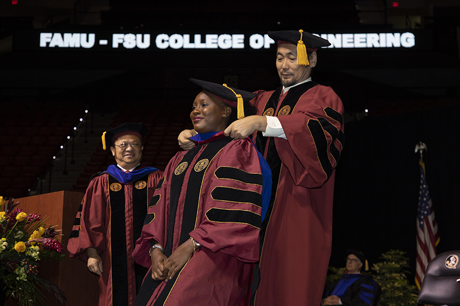 A Florida State University faculty hoods a doctoral graduate during a special ceremony Friday, May 5, 2023, at the Donald L. Tucker Civic Center. (FSU Photography)