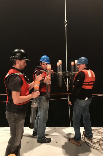 Researchers Michael Stukel, Tom Kelly, and Mike Landry recovering tubes from a sediment trap. (Courtesy of Michael Stukel)