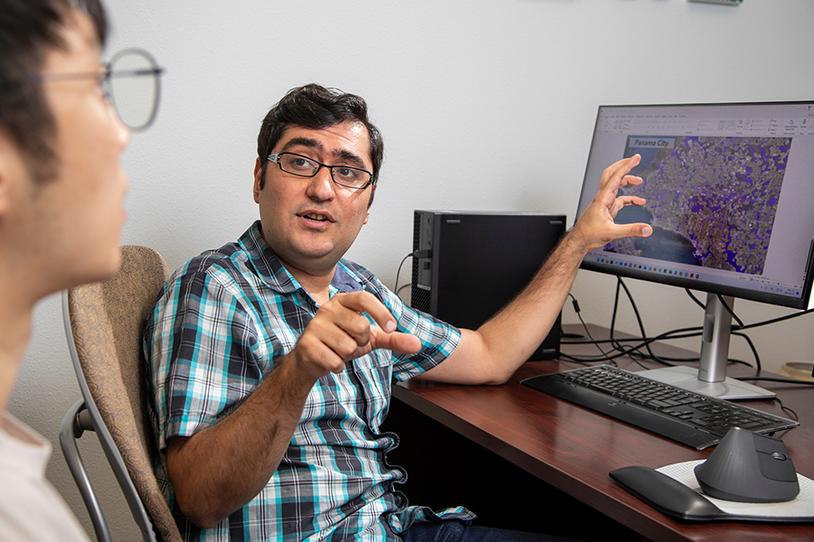 Ebrahim Ahmadisharaf, a researcher at the Resilient Infrastructure and Disaster Response Center in the FAMU-FSU College of Engineering, talks with postdoctoral researcher Eunsaem Cho. (Mark Wallheiser/FAMU-FSU College of Engineering)