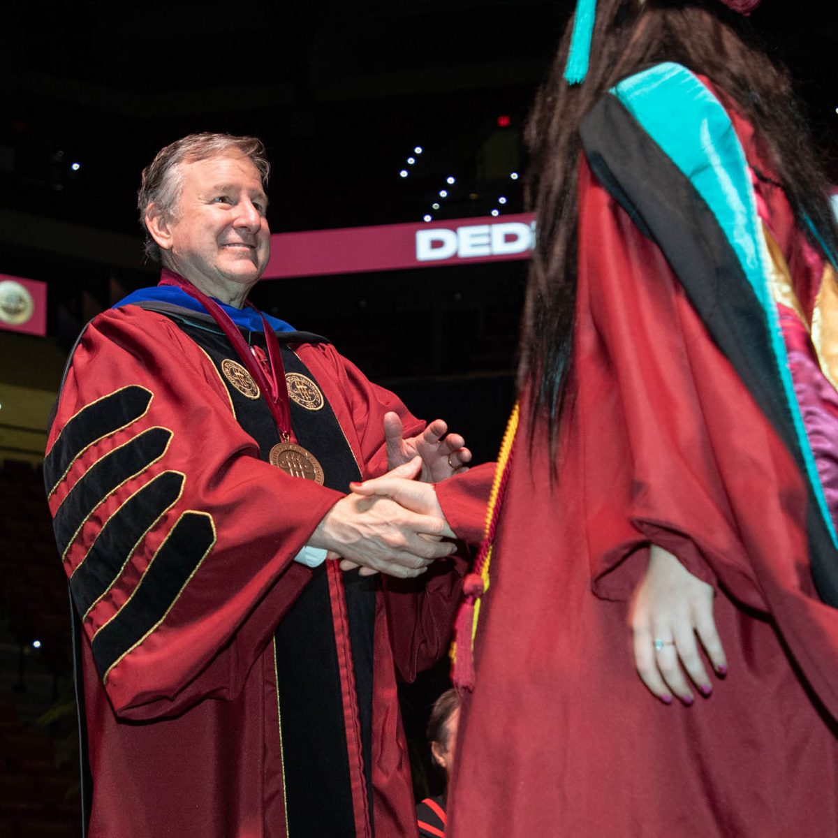 Florida State University President Richard McCullough congratulates a graduate during the summer commencement Friday, Aug. 4, 2023, at the Donald L. Tucker Civic Center. (FSU Photography Services)