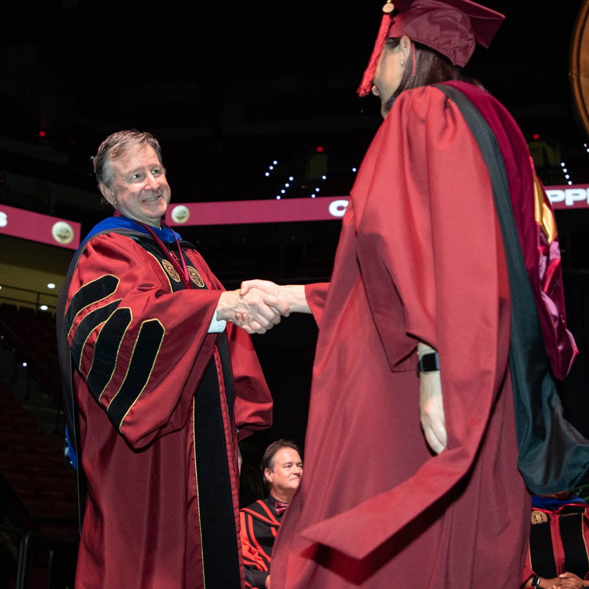 Florida State University President Richard McCullough congratulates a graduate during the summer commencement Friday, Aug. 4, 2023, at the Donald L. Tucker Civic Center. (FSU Photography Services)