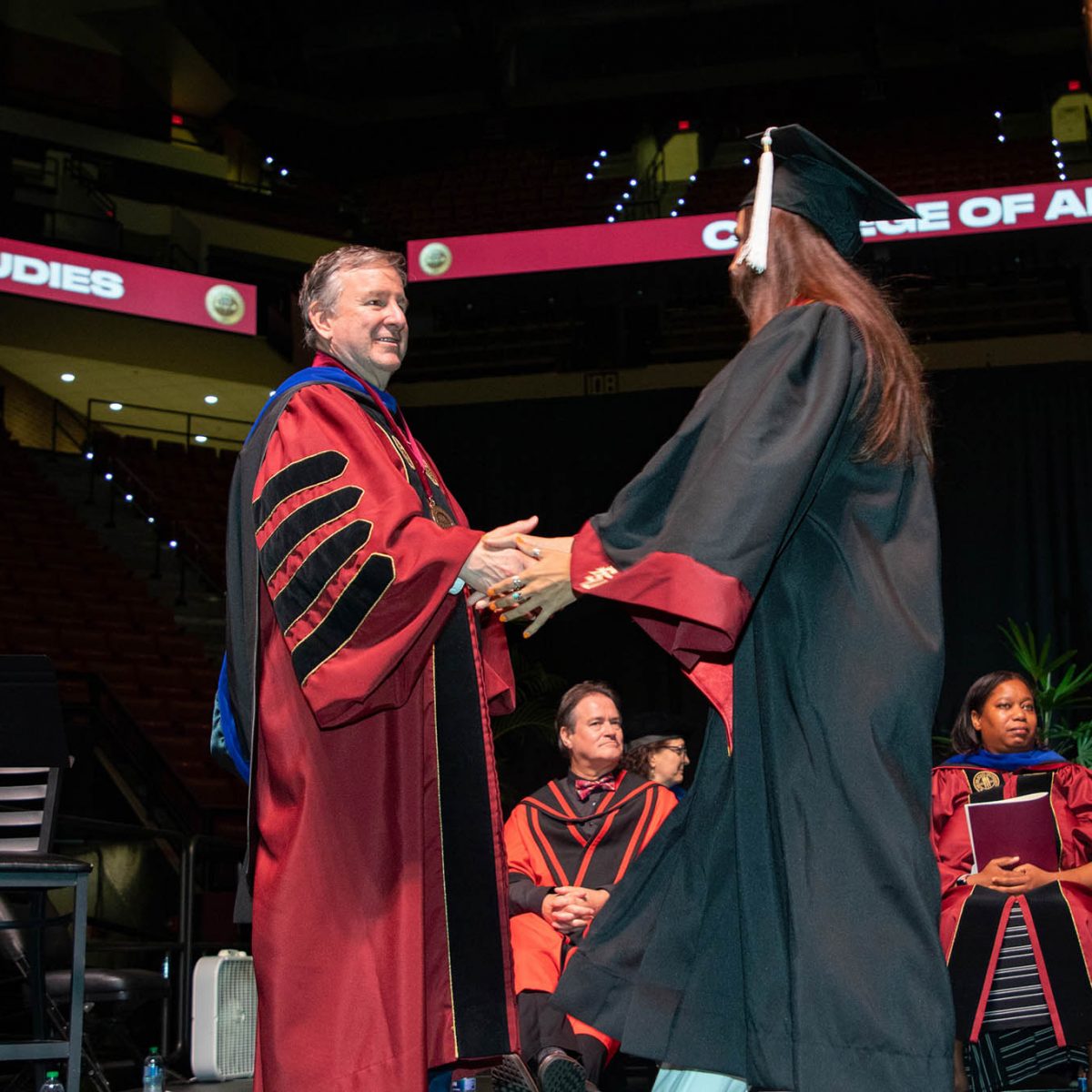 Florida State University President Richard McCullough congratulates a graduate during the summer commencement Friday, Aug. 4, 2023, at the Donald L. Tucker Civic Center. (FSU Photography Services)