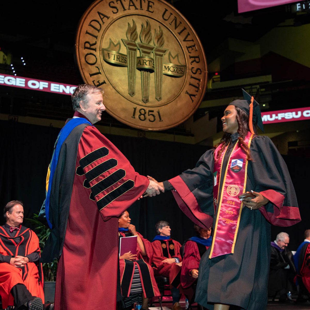 Florida State University President Richard McCullough congratulates a graduate during the summer commencement Friday, Aug. 4, 2023, at the Donald L. Tucker Civic Center. (FSU Photography Services)