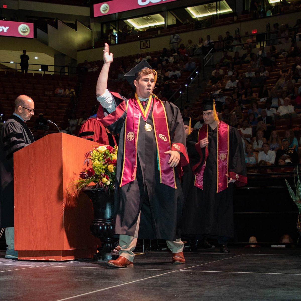 A Florida State University graduate celebrates during summer commencement Friday, Aug. 4, 2023, at the Donald L. Tucker Civic Center. (FSU Photography Services)