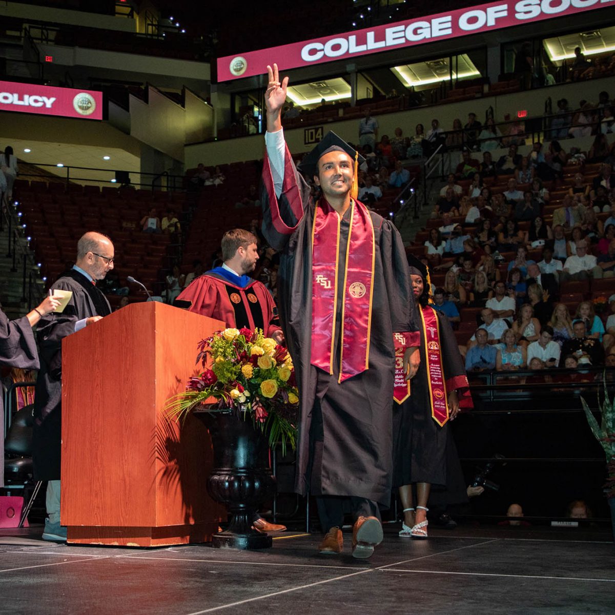 A Florida State University graduate celebrates during summer commencement Friday, Aug. 4, 2023, at the Donald L. Tucker Civic Center. (FSU Photography Services)