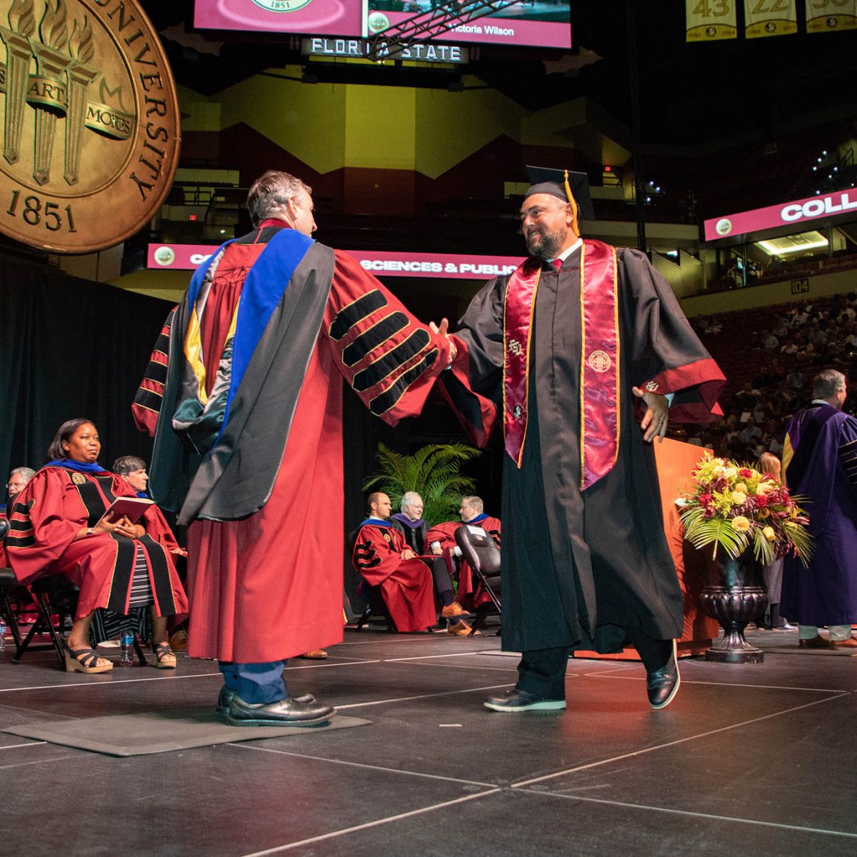 Florida State University President Richard McCullough congratulates a graduate during the summer commencement Friday, Aug. 4, 2023, at the Donald L. Tucker Civic Center. (FSU Photography Services)