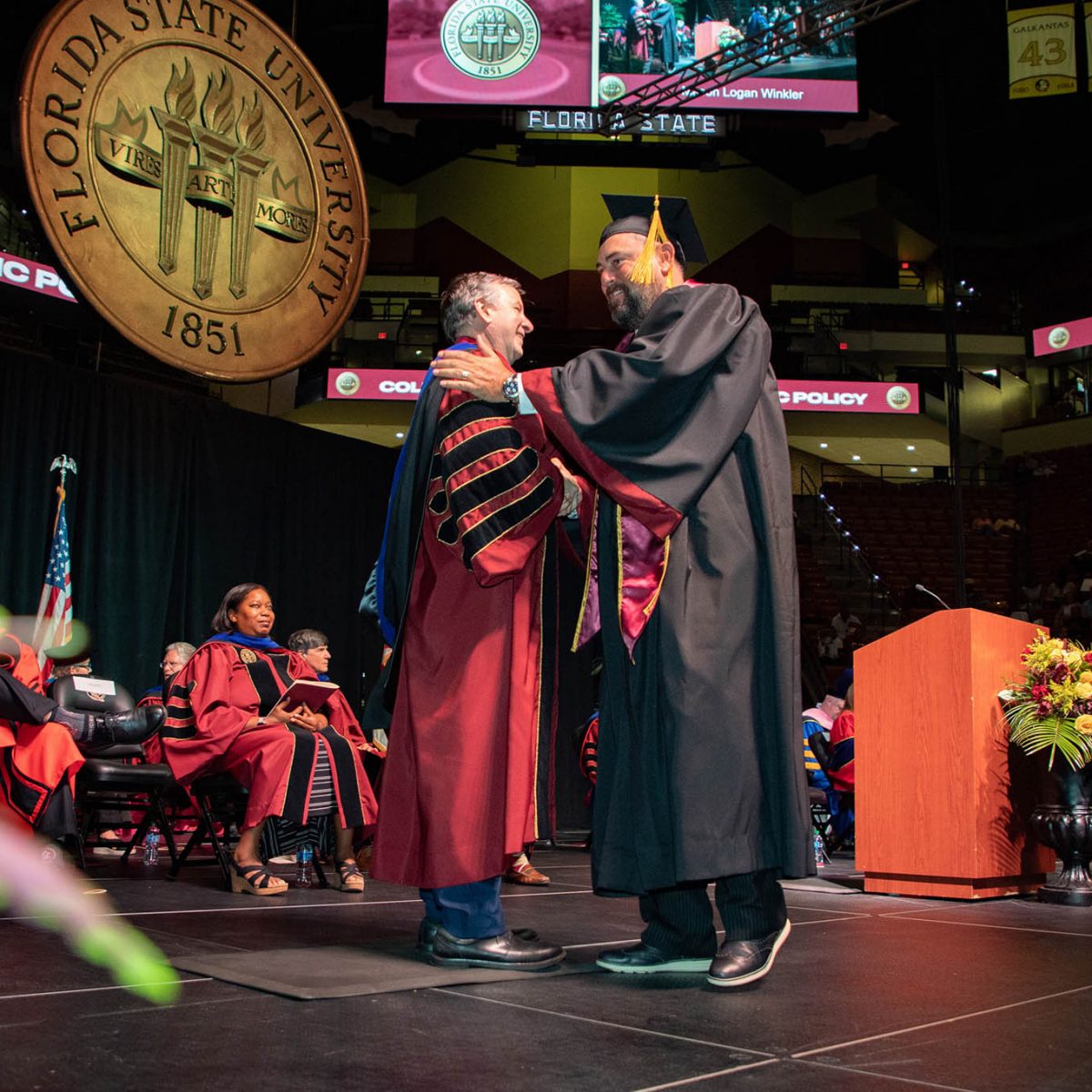 Florida State University President Richard McCullough congratulates a graduate during the summer commencement Friday, Aug. 4, 2023, at the Donald L. Tucker Civic Center. (FSU Photography Services)