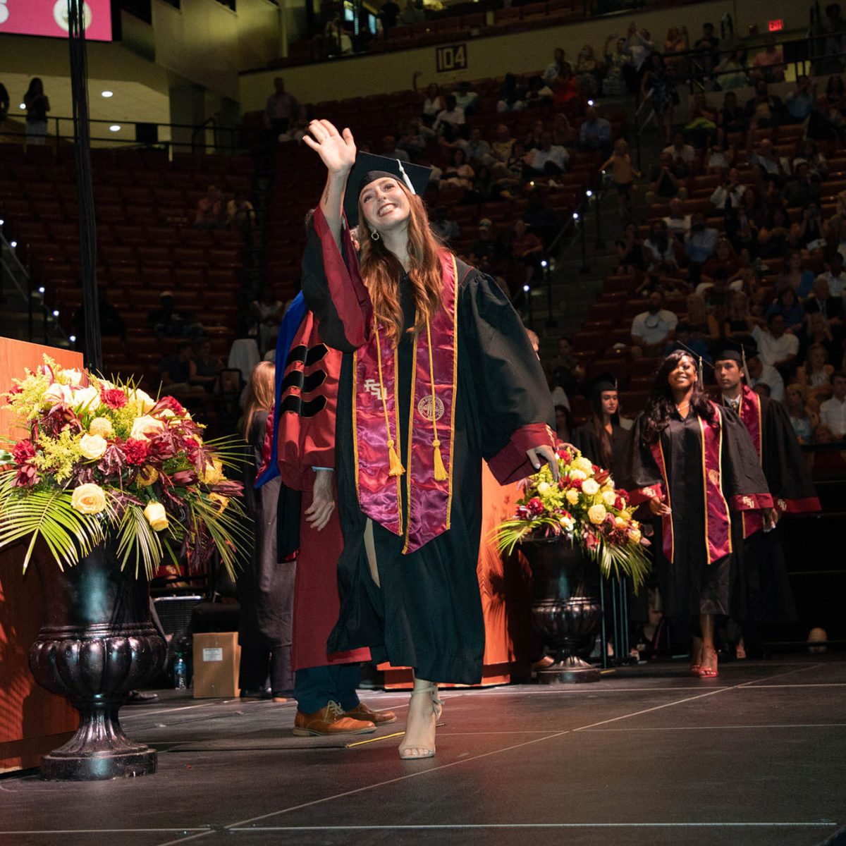 A Florida State University graduate celebrates during summer commencement Friday, Aug. 4, 2023, at the Donald L. Tucker Civic Center. (FSU Photography Services)