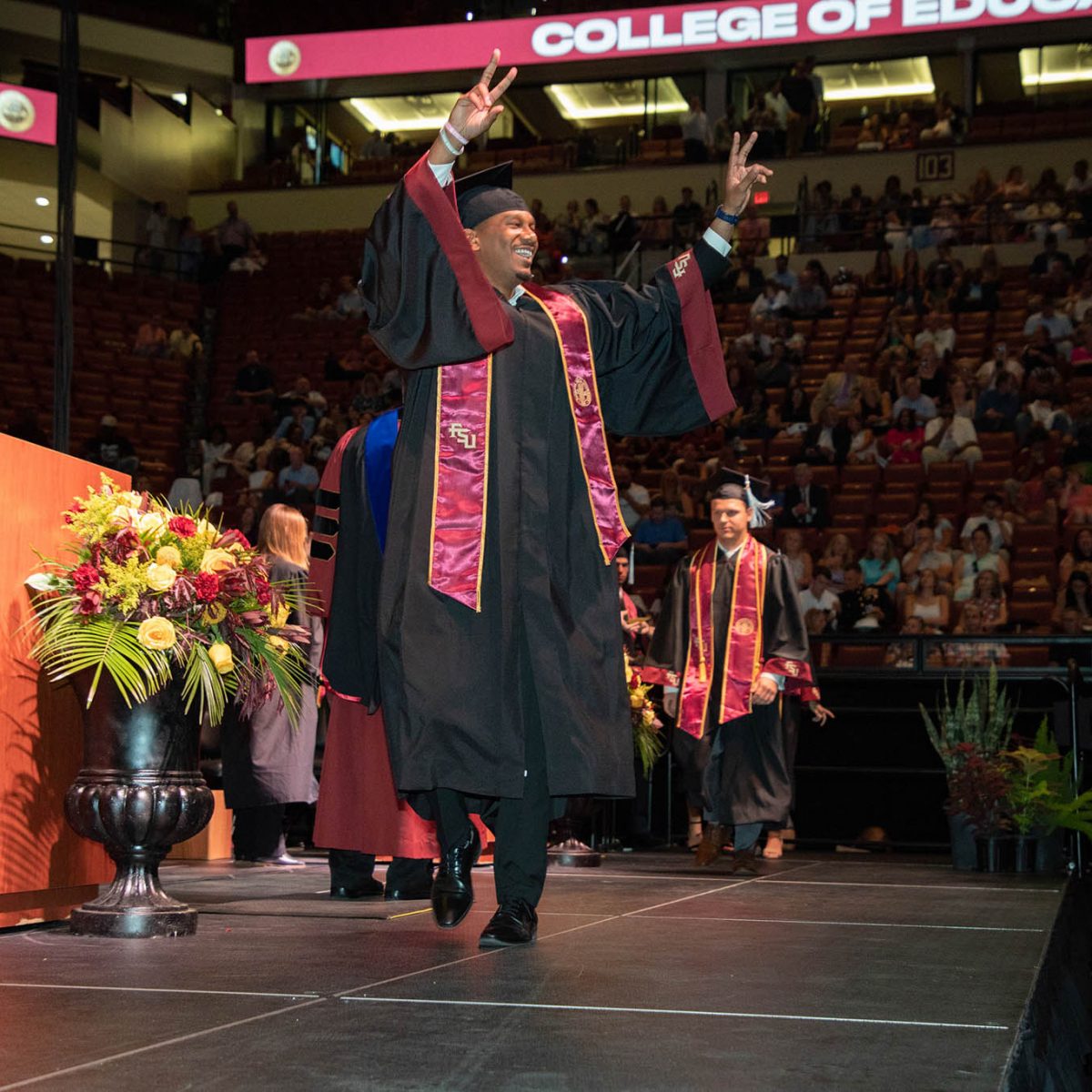 A Florida State University graduate celebrates during summer commencement Friday, Aug. 4, 2023, at the Donald L. Tucker Civic Center. (FSU Photography Services)