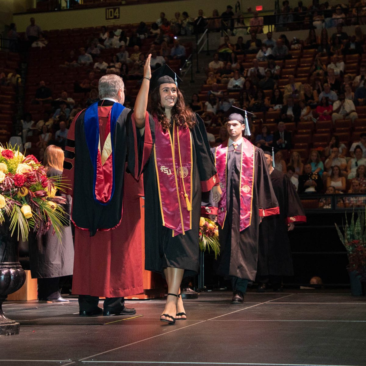 A Florida State University graduate celebrates during summer commencement Friday, Aug. 4, 2023, at the Donald L. Tucker Civic Center. (FSU Photography Services)