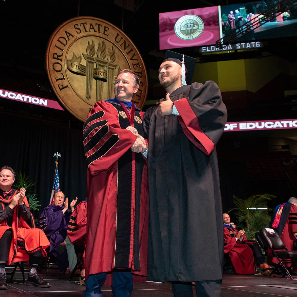 Florida State University President Richard McCullough congratulates a graduate during the summer commencement Friday, Aug. 4, 2023, at the Donald L. Tucker Civic Center. (FSU Photography Services)