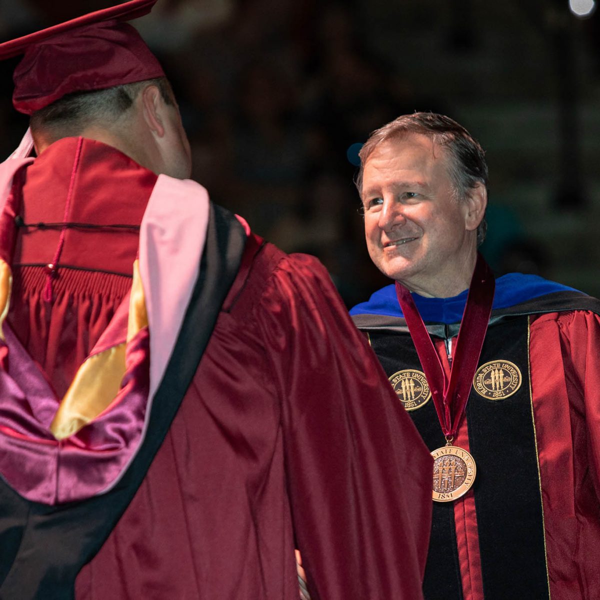 Florida State University President Richard McCullough congratulates a graduate during the summer commencement Friday, Aug. 4, 2023, at the Donald L. Tucker Civic Center. (FSU Photography Services)