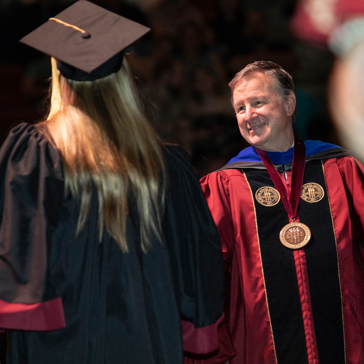 Florida State University President Richard McCullough congratulates a graduate during the summer commencement Friday, Aug. 4, 2023, at the Donald L. Tucker Civic Center. (FSU Photography Services)