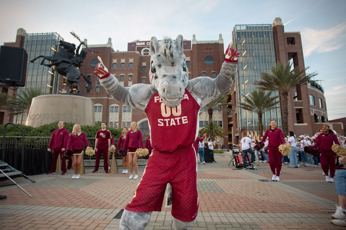 FSU Cheerleading and university ambassador Cimarron perform at the championship celebration at the Unconquered Statue, Dec. 5, 2023. (FSU Photography)