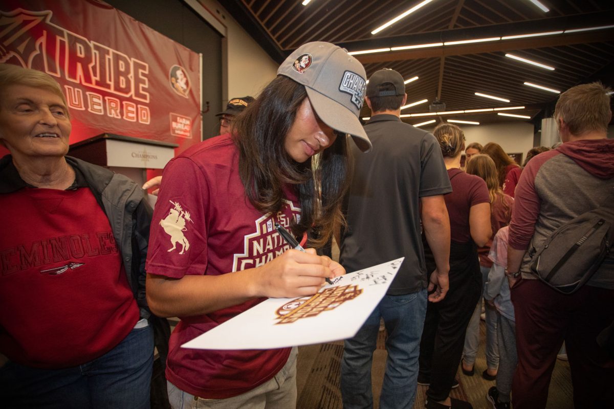 Florida State Women's Soccer team member Mimi Van Zanten signs autographs at the championship ceremony, Dec. 5, 2023. (FSU Photography)