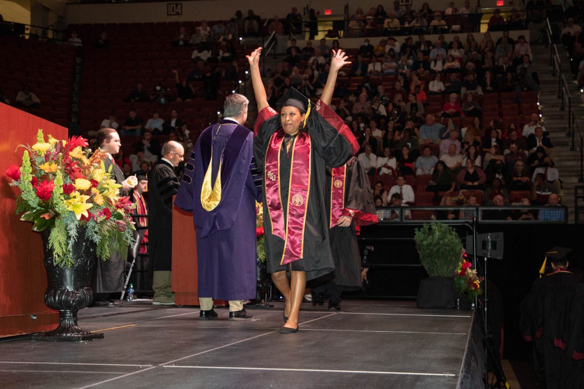 A student celebrates during commencement Friday, Dec. 15, 2023, at the Donald L. Tucker Civic Center. (FSU Photography Services)