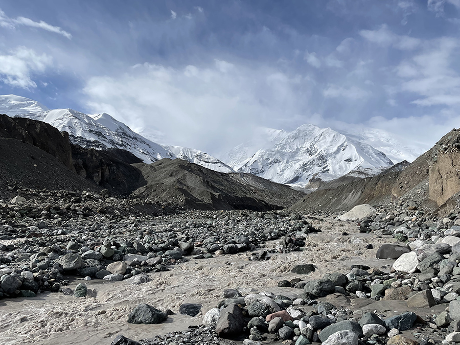 The pictured river in Kyrgyzstan was one of 136 sources of glacial meltwater sampled by postdoctoral scholar Amy Holt and her international research team. Lenin Peak, a summit that reaches nearly 4.5 miles above sea level, can be seen in the background. (Courtesy of Amy Holt)