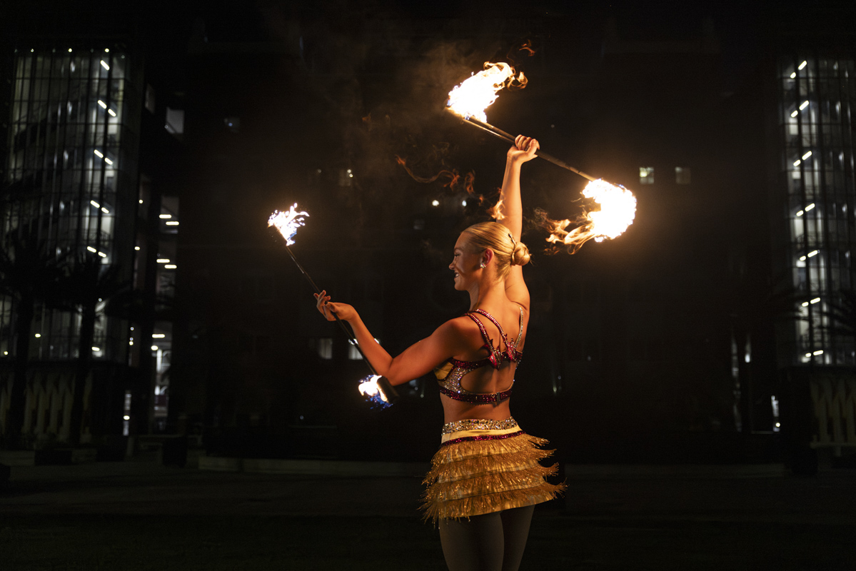 FSU Marching Chiefs Feature Twirler Kylee Saltsman performs with twirling flaming batons in front of Doak Campbell Stadium. (Matthew McConnell/Florida State University)
