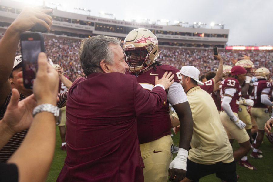 FSU President Richard McCullough hugs a player on the field as the Florida State Seminoles defeat the Alabama Crimson Tide 31-17 at Doak Campbell Stadium on August 30, 2025. (Matthew McConnell/Florida State University)