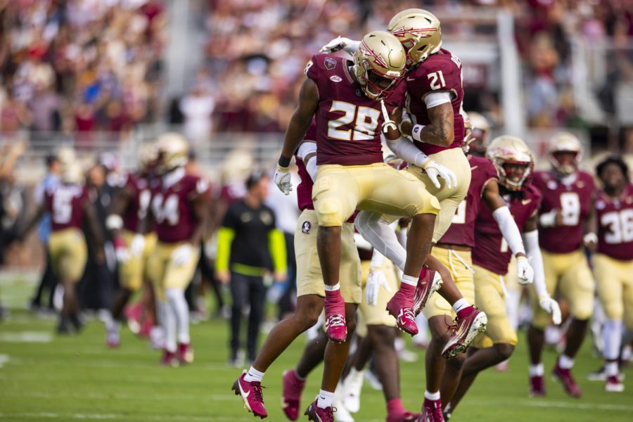Football players jump up in the air