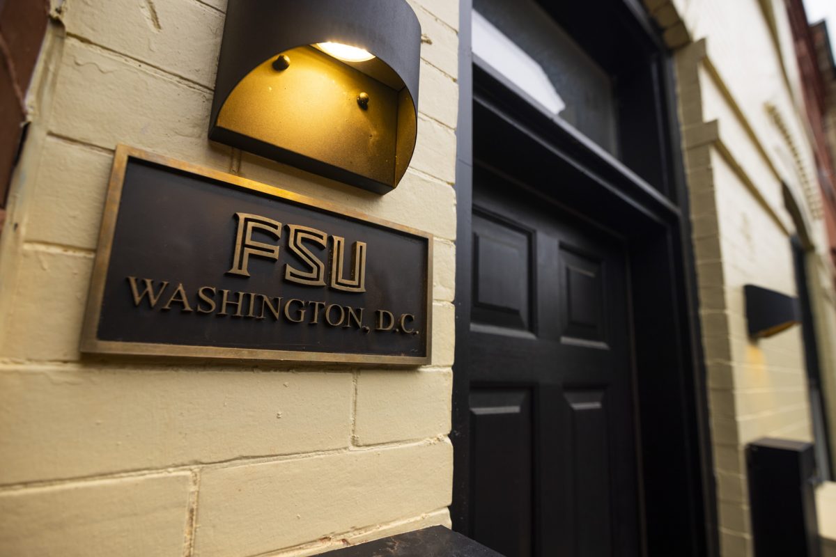 Up close photo of FSU Washington D.C plaque on tan brick building