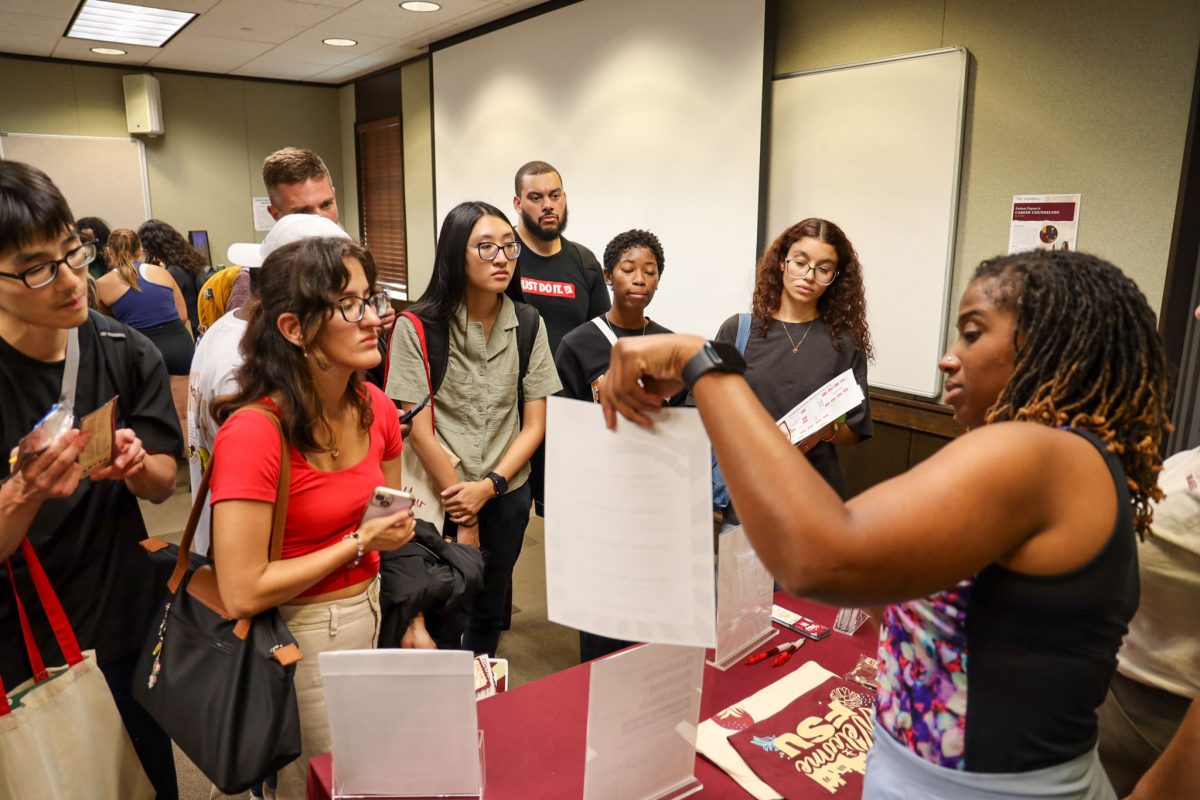 Students look at another person holding up a piece of paper