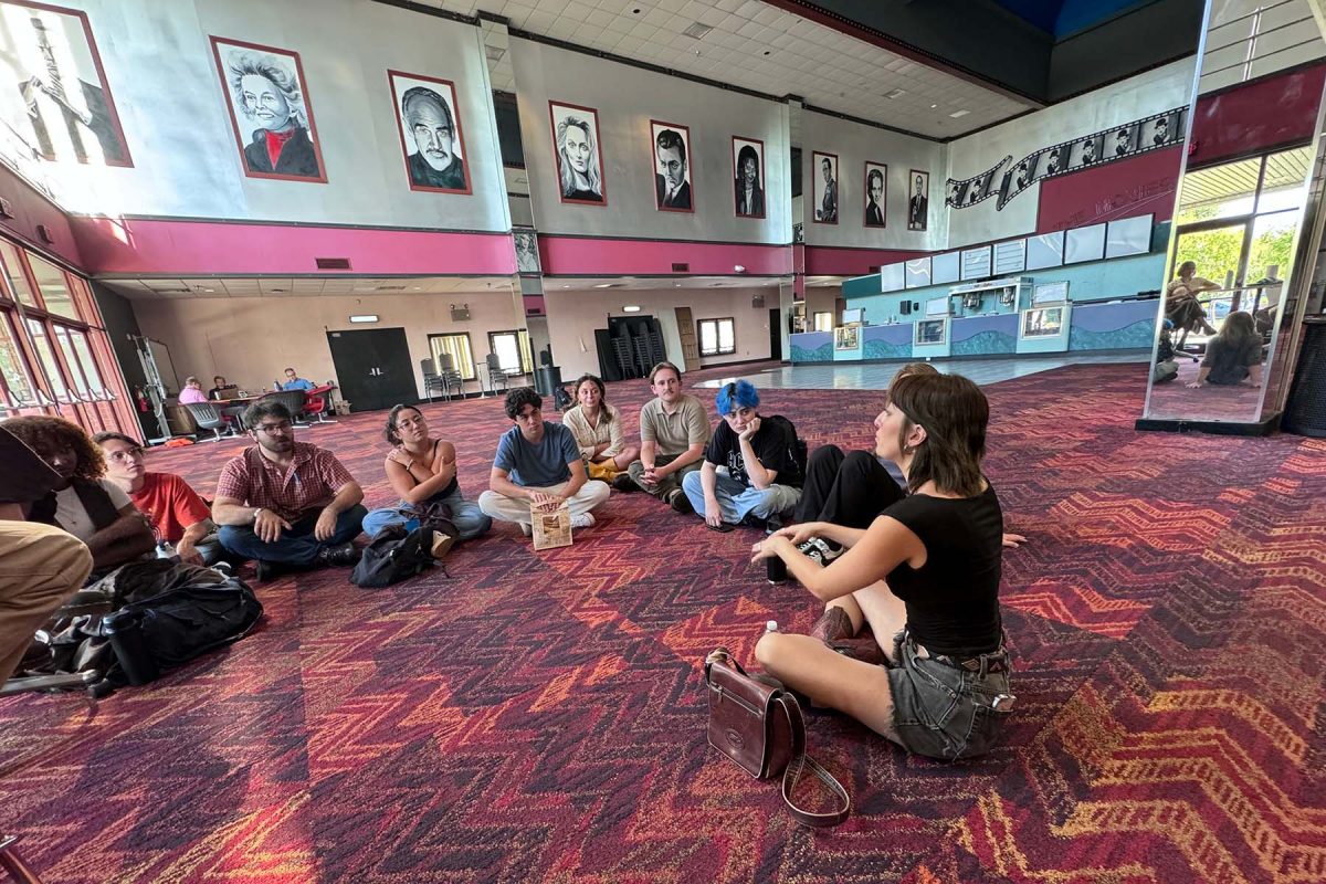 Students sit on the floor, mingling