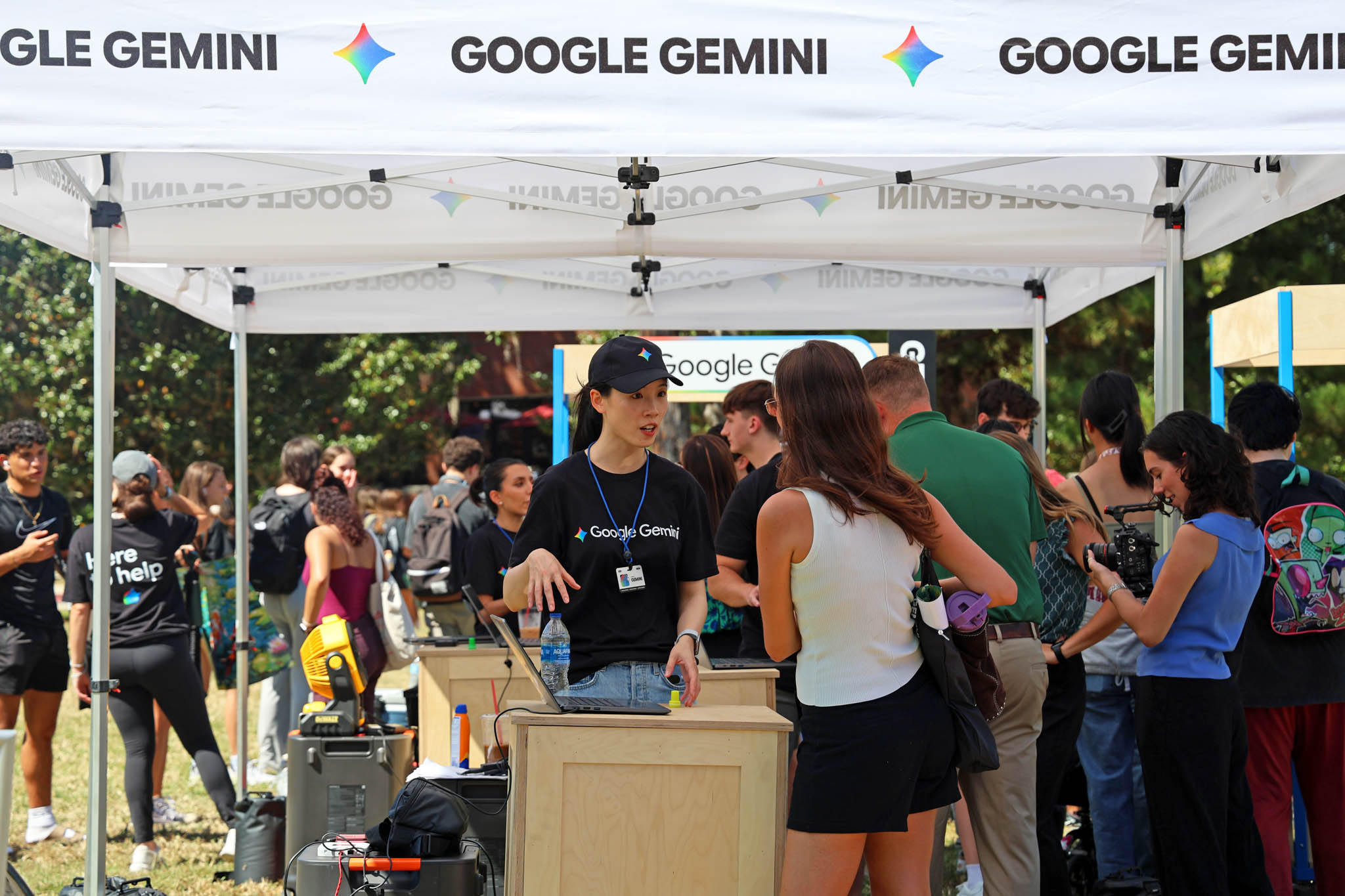 People looking at a computer at Google Gemini event