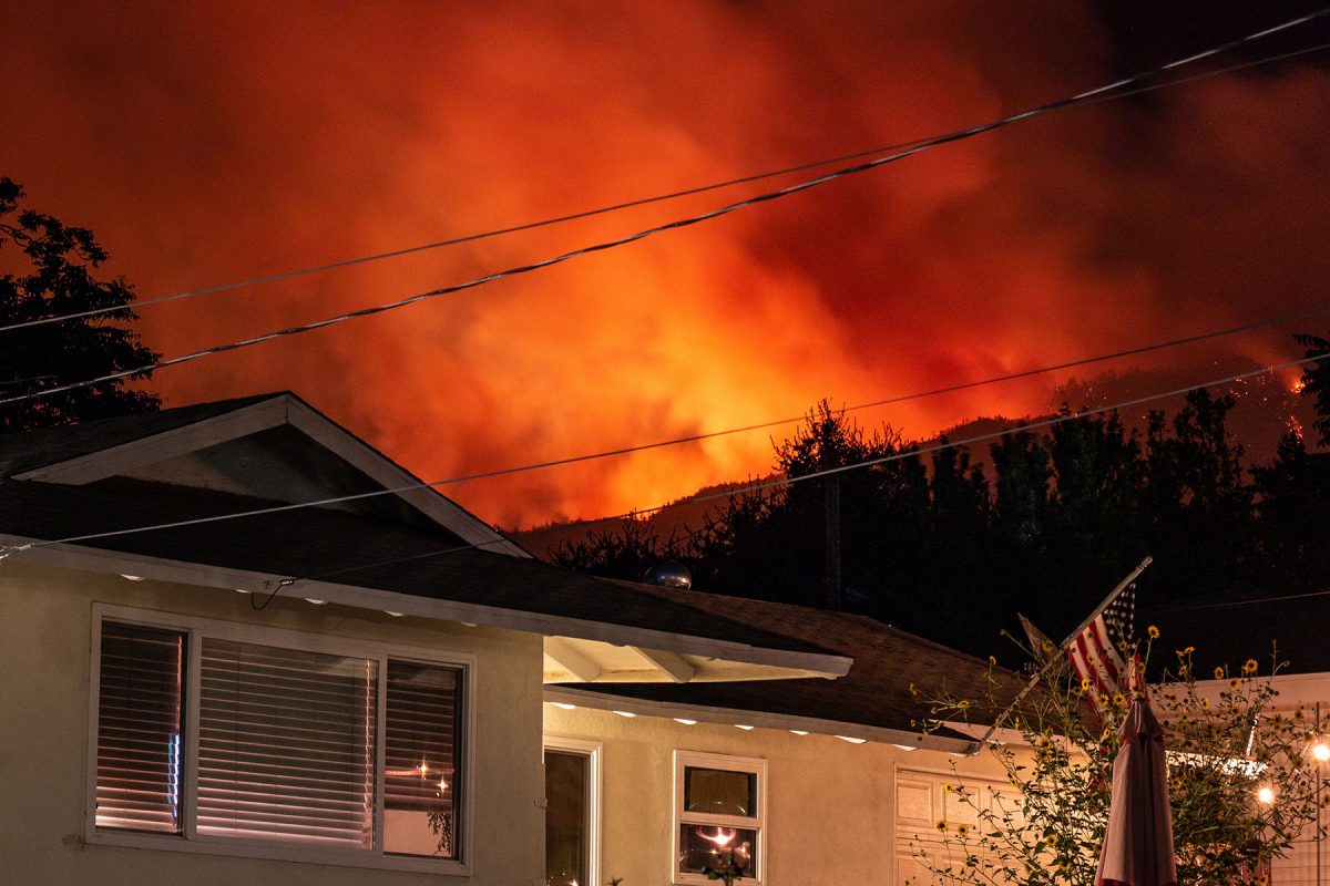 Stock photo of fire behind a house
