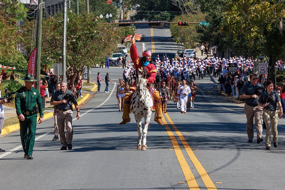 Many people walk the street of FSU's homecoming parade