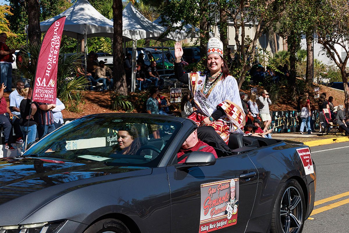 Person waves out of a car at FSU's homecoming parade