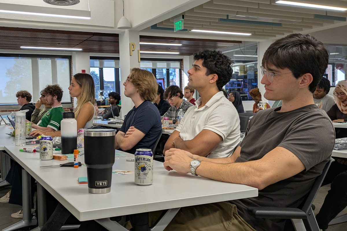 Students sit at a table at the Innovation hub