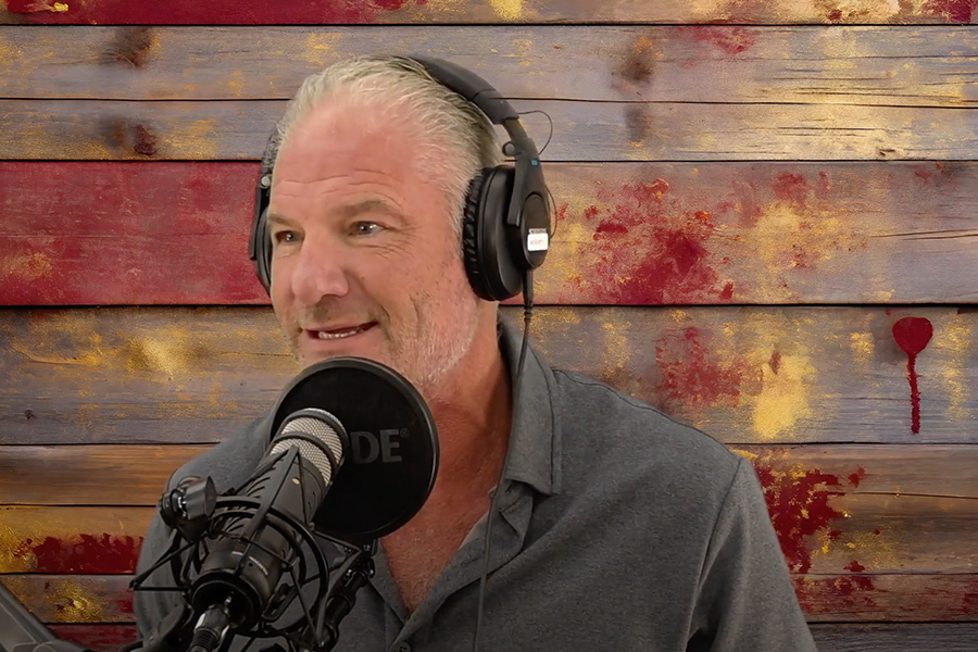 Mark McNees speaks into a microphone