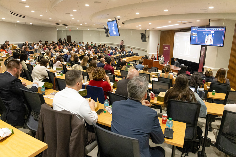 People sit and watch presentation
