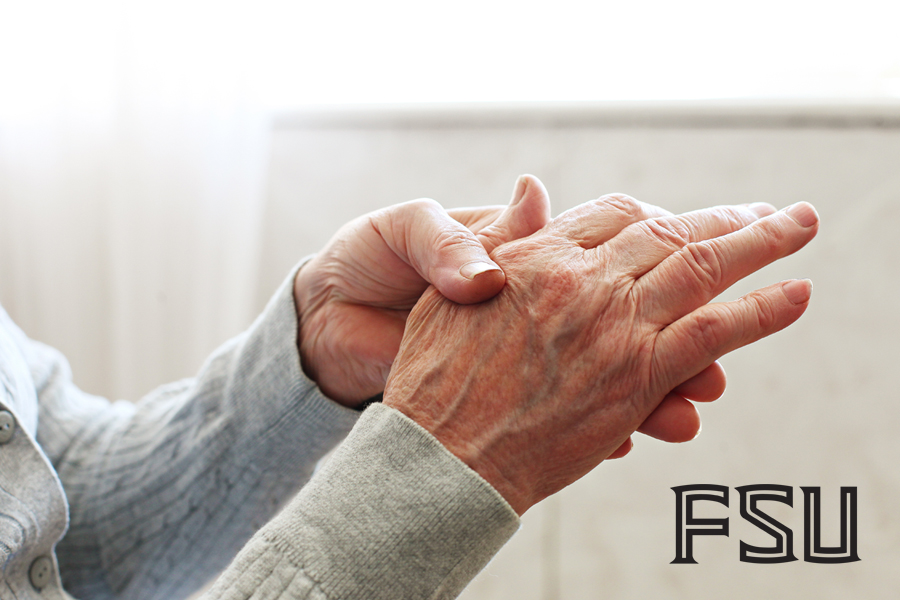 Photo of an older person massaging their own hands, with FSU logo on the bottom right